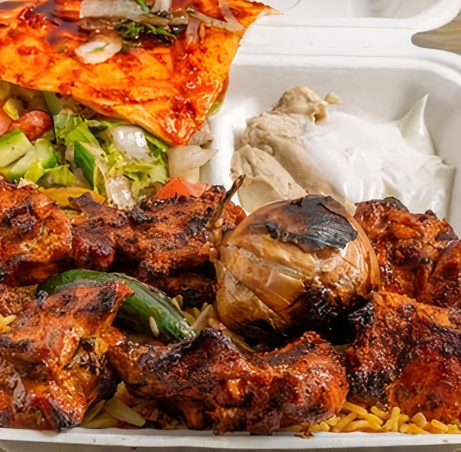 Chicken tandoori skewers grilled over charcoal at Donya Kebab in London, Ontario