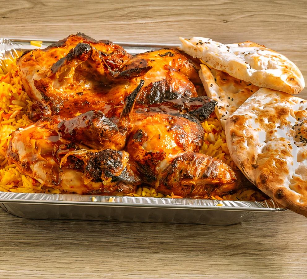 Full chicken dinner special on charcoal with rice and flatbread at Donya Kebab in London, Ontario