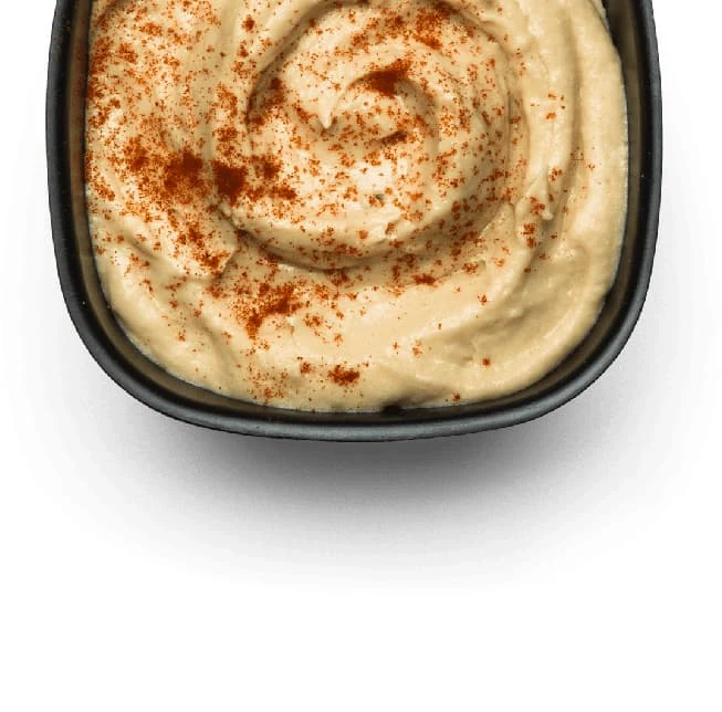 Creamy hummus and garlic sauce tomeya served with warm bread at Donya Kebab in London, Ontario